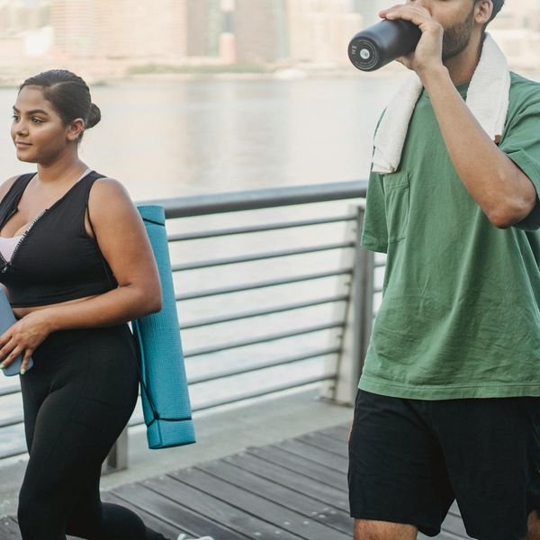 Yoga mat, water bottle, and small towel neatly arranged.